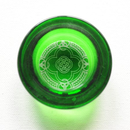 Green Spindle bowl with a white celtic knot design on the bottom, shown from the top down.