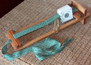 Beka 4 Inch Rigid Heddle Loom - Shown here holding a cardweaving project.